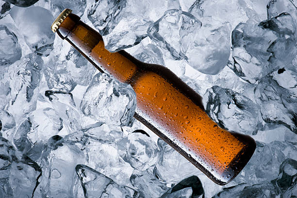Cold beer bottle with smoke with ice cube