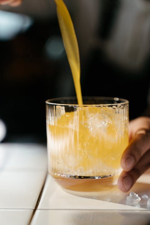 a cocktail standing on the edge of a counter