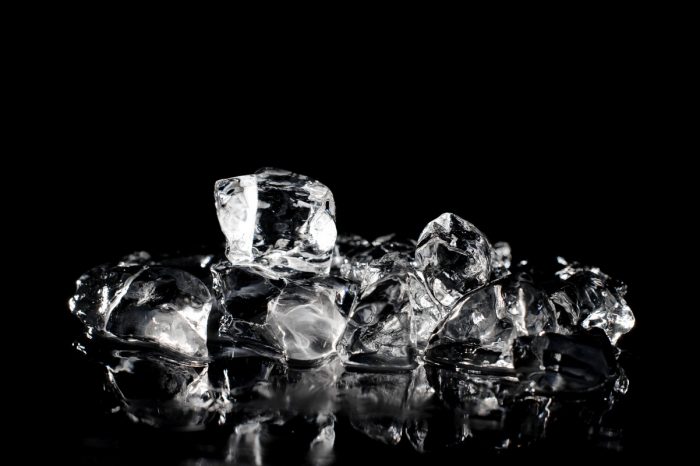 An image of ice cubes arranged in a pile on black background