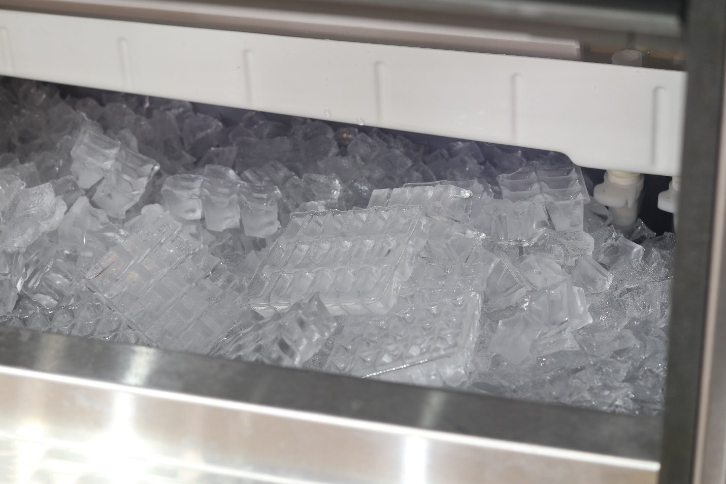 a close-up short of ice cubes in an ice machine