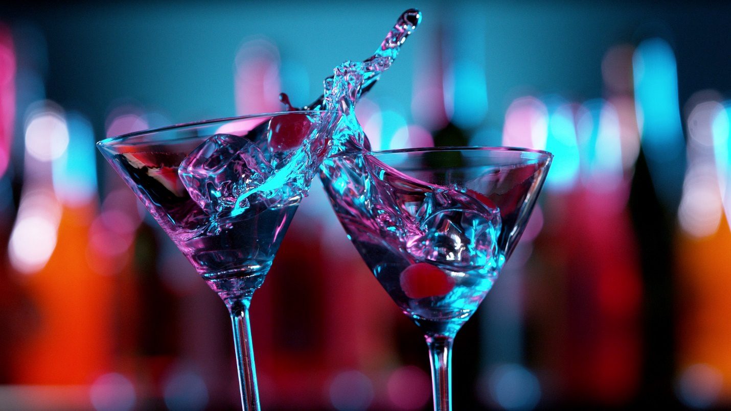 two martini glasses with ice in the craft cocktail