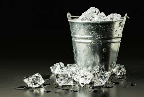 An image of a bucket filled with ice cubes from an ice machine