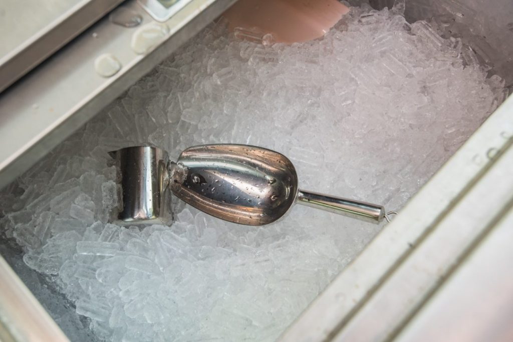 An image of ice cubes and a scoop in an ice machine
