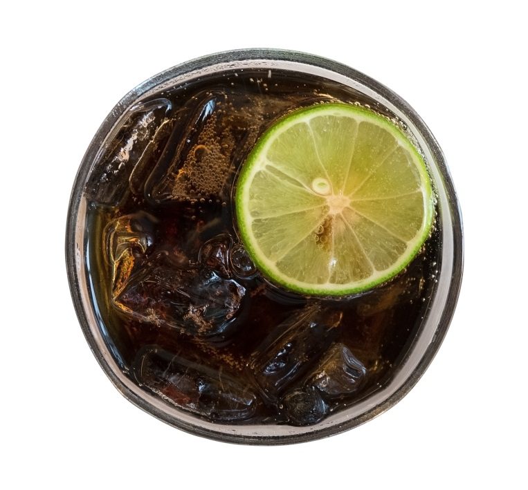 An image of ice cubes and lemon in a glass of Coke  