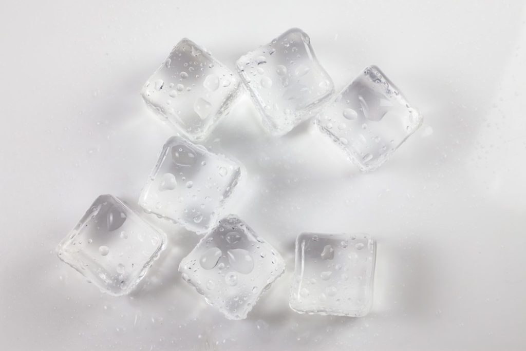 Ice cubs against a white surface.