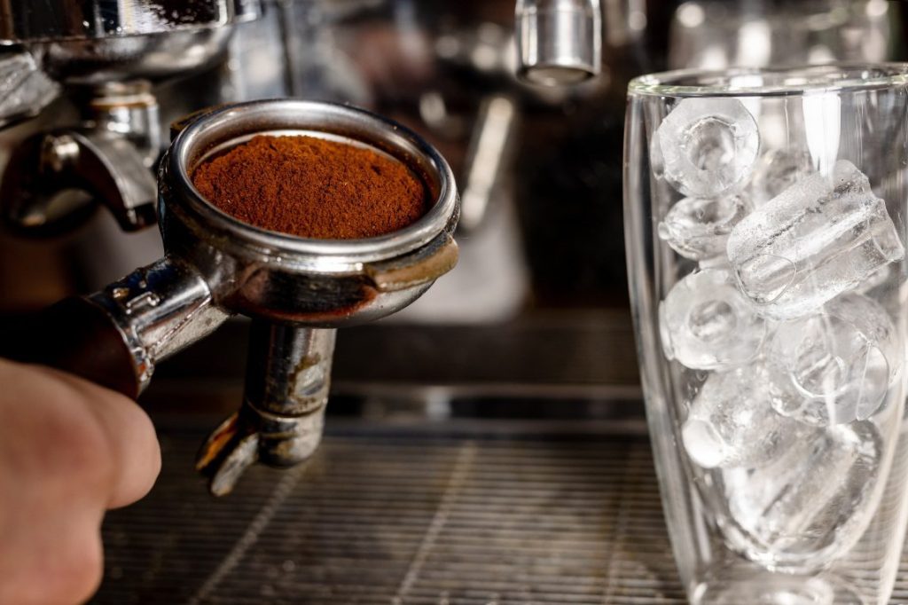 Ground coffee and a glass of ice.