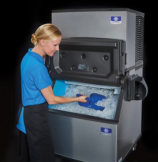 a woman taking out ice from an ice machine 